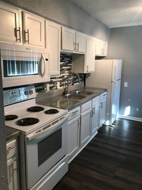 Galley kitchen with white appliances