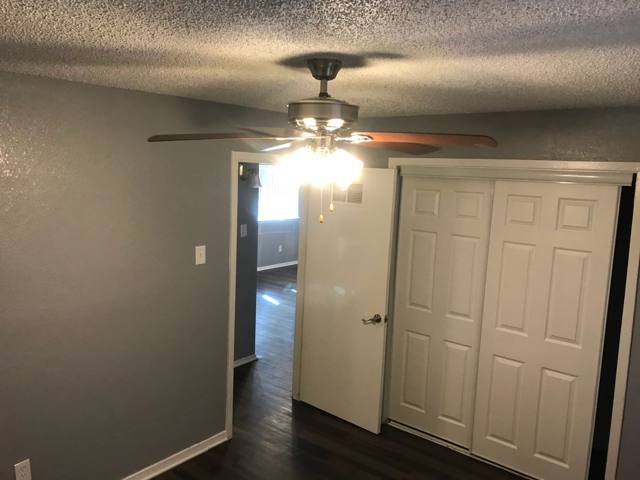 Bedroom with ceiling fan and closet